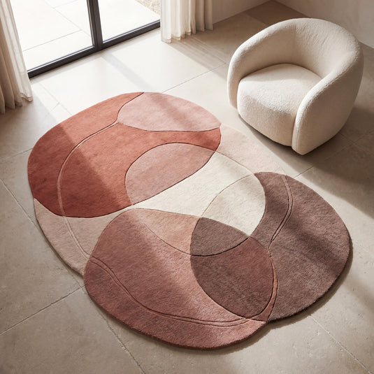 Translation missing: es.Handmade abstract wool rug in blush, terracotta, and beige tones styled in a modern minimalist living room with curved accent chair __etsy:8018081228