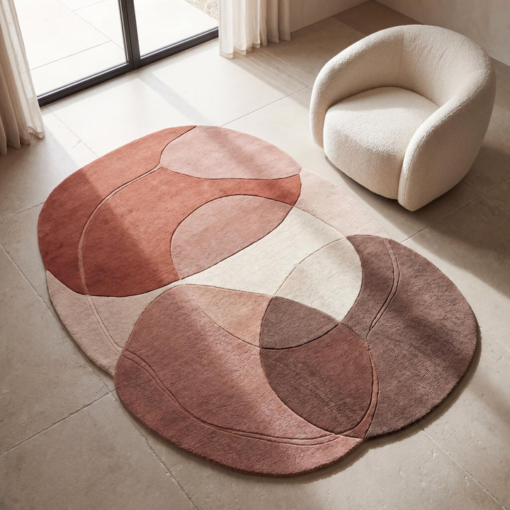 Translation missing: es.Handmade abstract wool rug in blush, terracotta, and beige tones styled in a modern minimalist living room with curved accent chair __etsy:8018081228