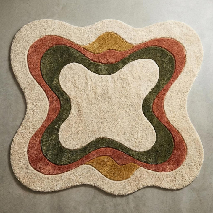 Translation missing: en.Top-down view of irregular shaped abstract area rug with curved earth tone pattern on cream background, modern boho sculpted carpet design fully visible