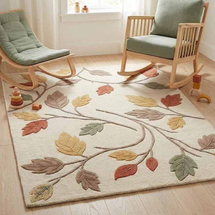 Translation missing: es.Soft botanical nursery rug with autumn leaf pattern placed in a cozy kids room, warm ivory and earthy tones creating calming and family-friendly atmosphere