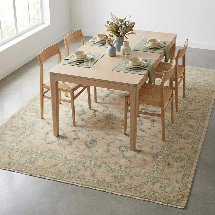 Translation missing: es.Neutral beige base rug with sage green and soft olive vine accents and tan border