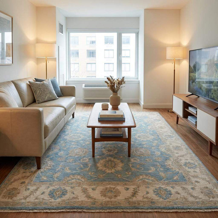 Translation missing: en.Blue and cream Oushak inspired rug paired with modern armchair