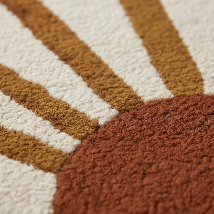Translation missing: es.Close-up of tufted sunrise rug with rich terracotta sun and rays