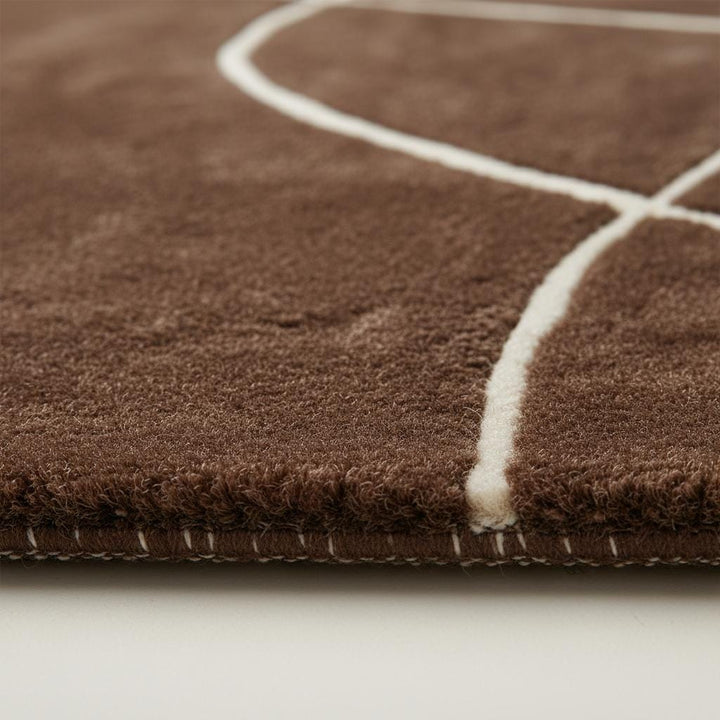Translation missing: en.Modern brown abstract rug with curved white lines and hand tufted design