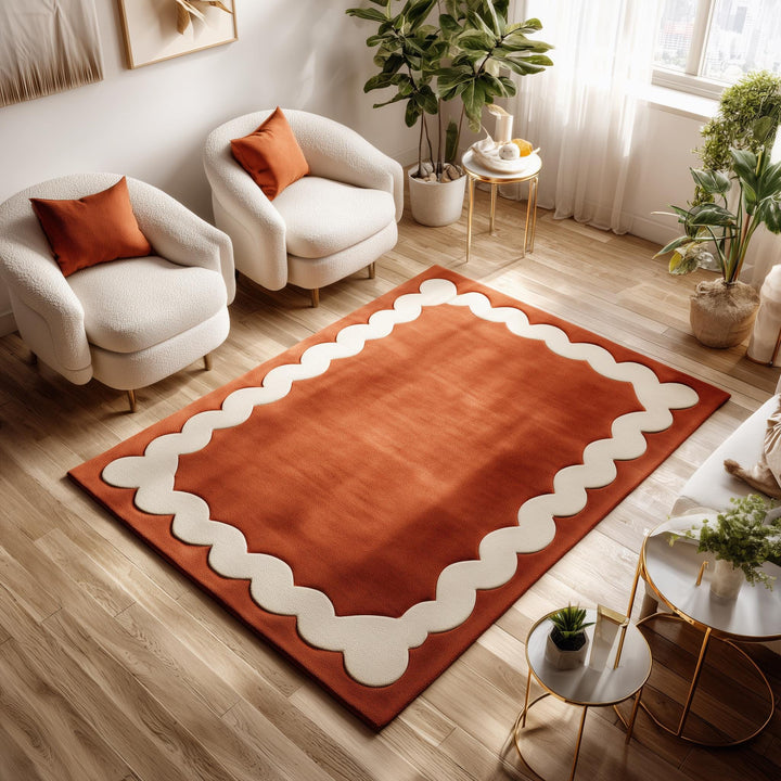 Translation missing: en.Burnt orange area rug with handmade tufted wool and wavy cream Scandinavian border