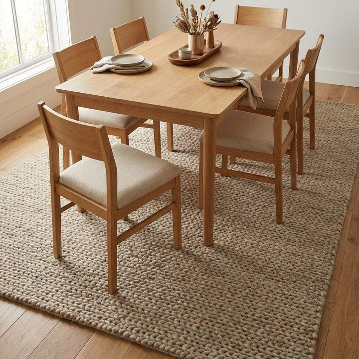 Translation missing: es.Chunky braided knit rug in neutral beige with thick textured yarn for cozy Nordic interiors