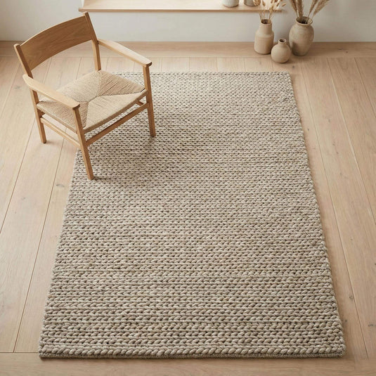 Translation missing: es.Chunky braided knit rug in neutral beige with thick textured yarn for cozy Nordic interiors