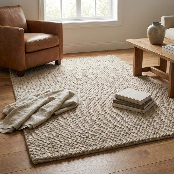 Translation missing: es.Chunky braided knit rug in neutral beige with thick textured yarn for cozy Nordic interiors