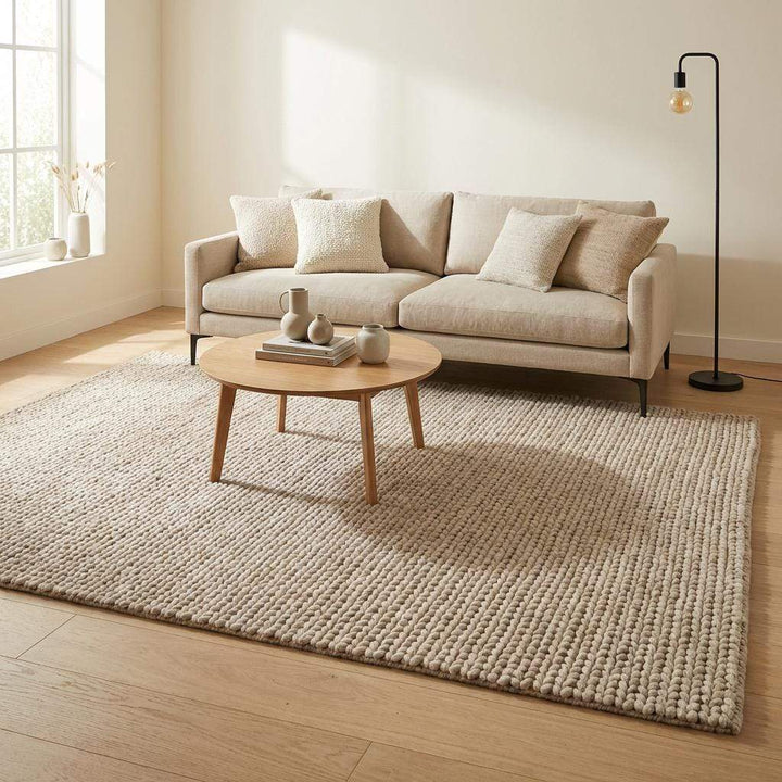 Translation missing: es.Chunky braided knit rug in neutral beige with thick, textured yarn for cozy Nordic interiors