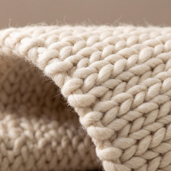 Translation missing: es.Chunky braided neutral rug with thick cream texture in cozy minimalist Scandinavian decor setting