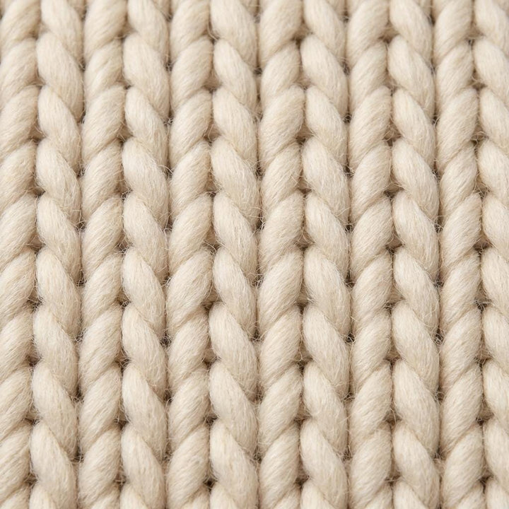 Translation missing: en.Detailed view of braided rug edge with oversized yarn strands and dense textured weave