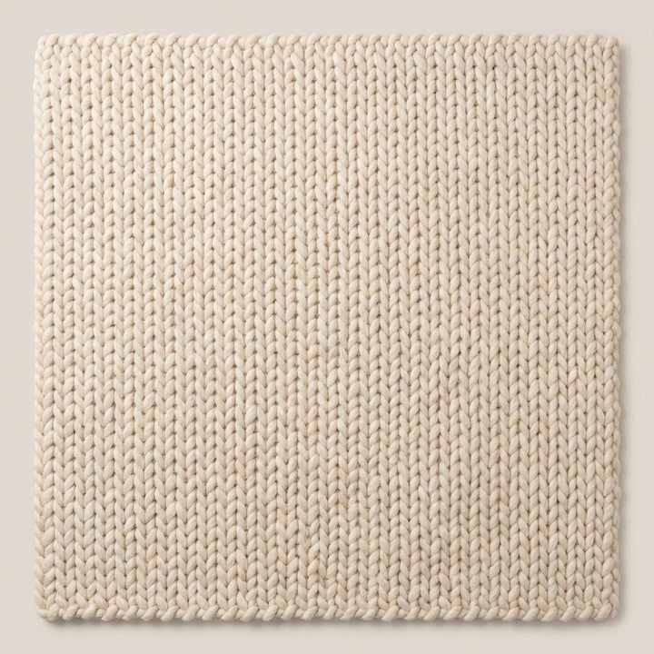 Translation missing: en.Macro shot highlighting the plush braided construction of a neutral cream textured rug