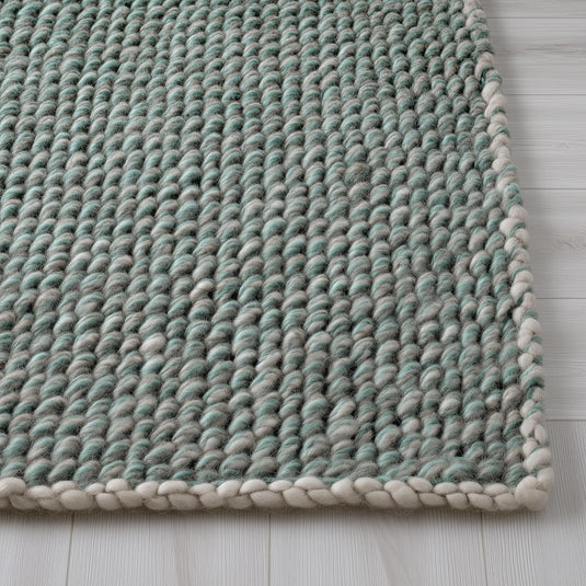 Translation missing: es.Chunky handknit wool rug in mint green and grey with braided ivory edge for cozy living room decor