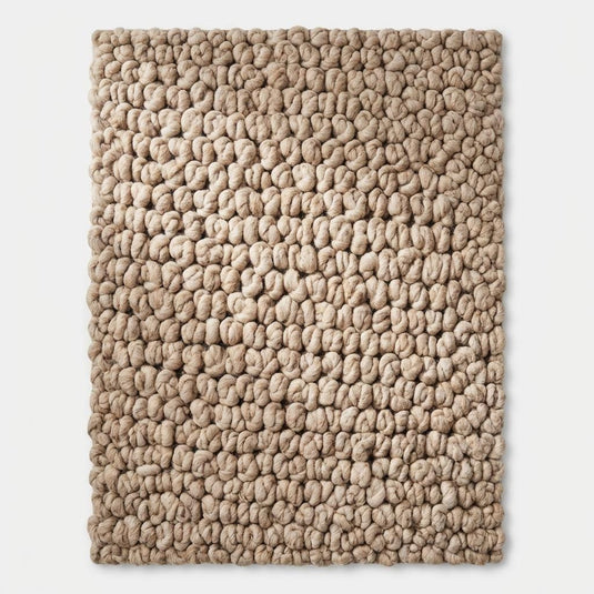 Translation missing: es.Top view of chunky knit area rug displaying full loop texture pattern, neutral beige tone and organic modern minimalist rug design