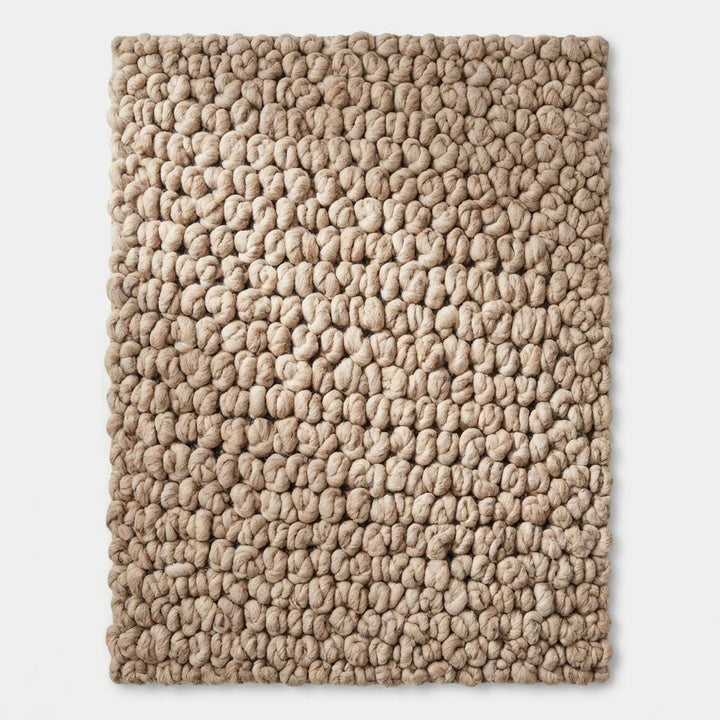 Translation missing: es.Top view of chunky knit area rug displaying full loop texture pattern, neutral beige tone and organic modern minimalist rug design