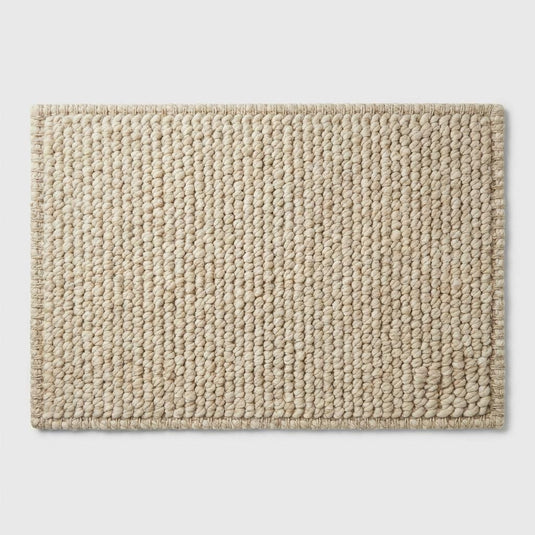 Translation missing: es.Chunky knit neutral rug with thick textured oversized yarn loops for cozy Scandinavian interiors