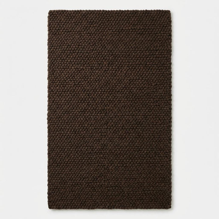 Translation missing: fr.Chunky knit rug in dark brown with thick braided roving texture for cozy modern organic interiors
