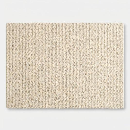 Translation missing: es.Chunky knit wool rug in cream with thick looped texture and plush soft surface for cozy, neutral floor accent