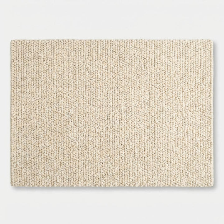 Translation missing: es.Chunky knit wool rug in cream with thick looped texture and plush soft surface for cozy, neutral floor accent