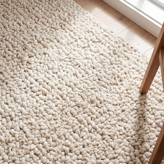 Translation missing: es.Handwoven chunky knit wool rug in ivory with thick loops, soft texture, and minimalist boho style for cozy living rooms