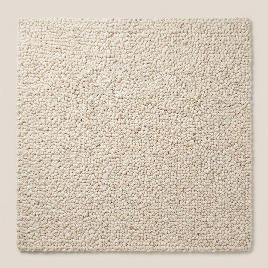 Translation missing: es.Top-down view of ivory chunky knit area rug highlighting dense loop texture, full surface coverage, and modern minimalist solid design