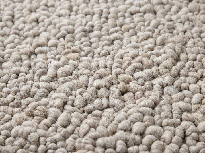 Translation missing: en.Close-up of chunky knit rug showing dense pebble texture, thick wool loops and handcrafted detail, soft plush fibers and premium texture finish