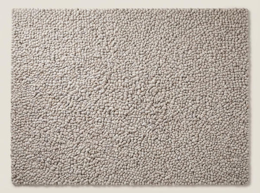 Translation missing: es.Top view of neutral chunky knit area rug with pebble texture, full surface visible showcasing consistent handmade loop design and soft beige tone