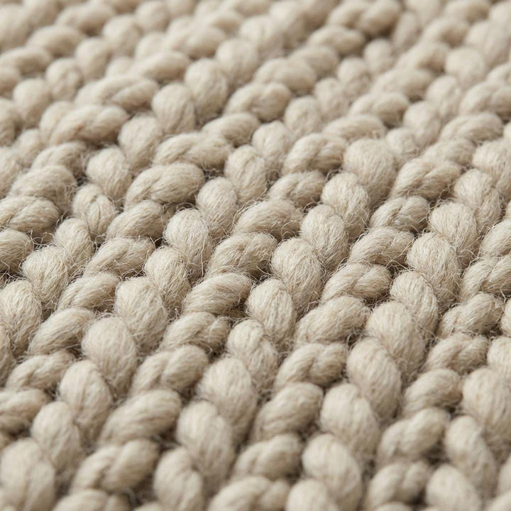 Translation missing: es.Chunky knit wool rug in neutral cream with thick, plush texture for cozy living room decor