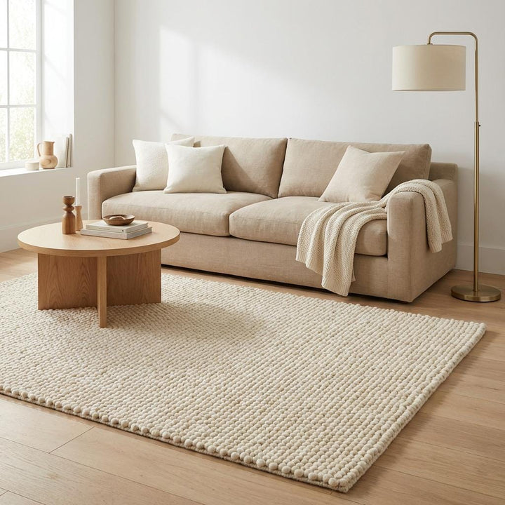 Translation missing: es.Chunky knit wool rug with thick, plush loops in neutral cream tone, perfect for cozy living rooms and nurseries