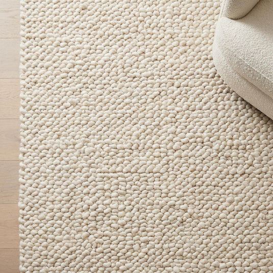Translation missing: es.Handmade chunky knit wool rug with thick ivory loops for cozy minimalist Scandinavian decor