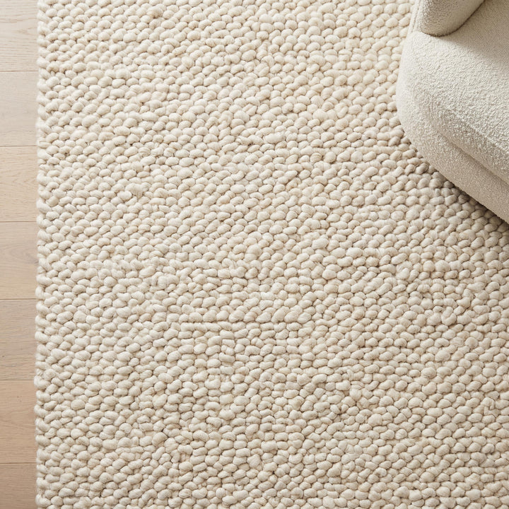 Translation missing: es.Handmade chunky knit wool rug with thick ivory loops for cozy minimalist Scandinavian decor