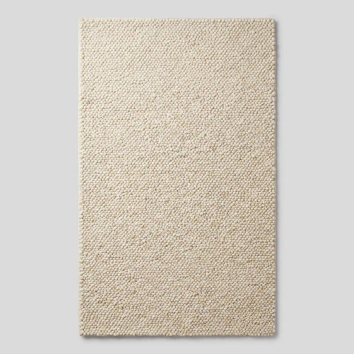 Translation missing: es.Ivory chunky knit wool rug with thick braided texture and soft natural fibers