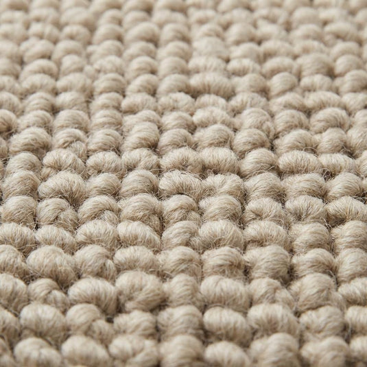 Translation missing: es.Close-up of oversized pebble loop texture in neutral beige rug