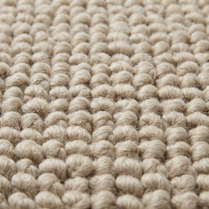 Translation missing: en.Close-up of oversized pebble loop texture in neutral beige rug