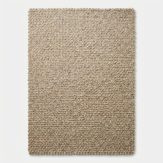 Translation missing: es.Top-down view of solid chunky textured rectangular beige floor rug