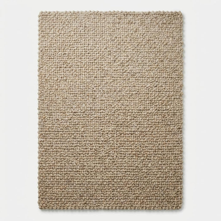 Translation missing: en.Top-down view of solid chunky textured rectangular beige floor rug