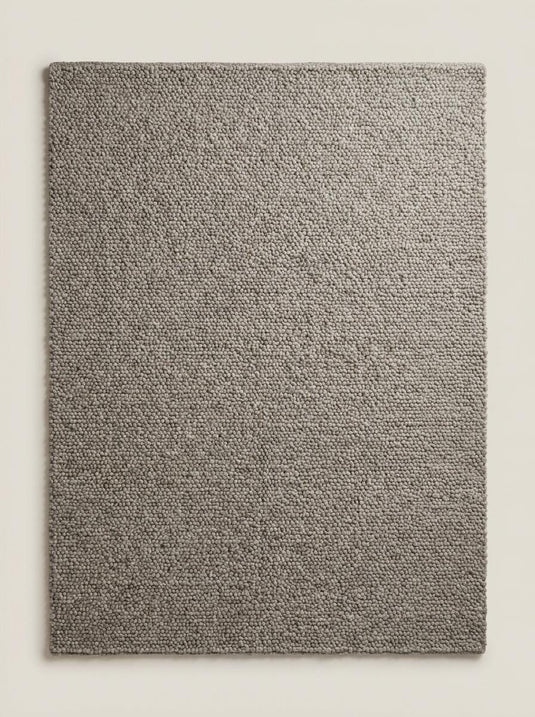 Translation missing: es.Neutral chunky loop rug partially rolled showing dense textured construction