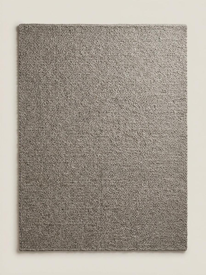 Translation missing: es.Neutral chunky loop rug partially rolled showing dense textured construction