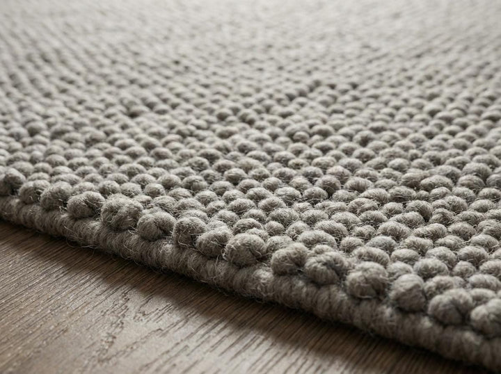 Translation missing: es.Detailed view of oversized loop pile texture in natural toned rug