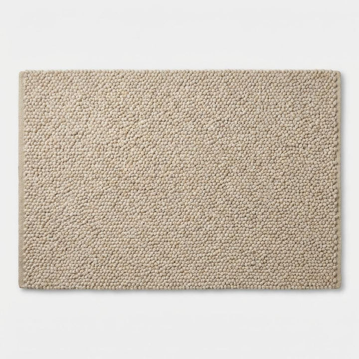 Translation missing: es.Top-down view of dense neutral loop rug showing dimensional surface