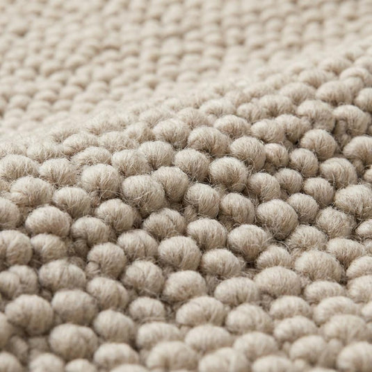 Translation missing: es.Cream minimalist textured rug surface highlighting dense looped yarn pattern