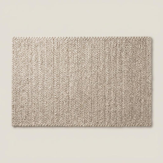 Translation missing: es.Folded neutral area rug revealing woven backing and thick textured edge