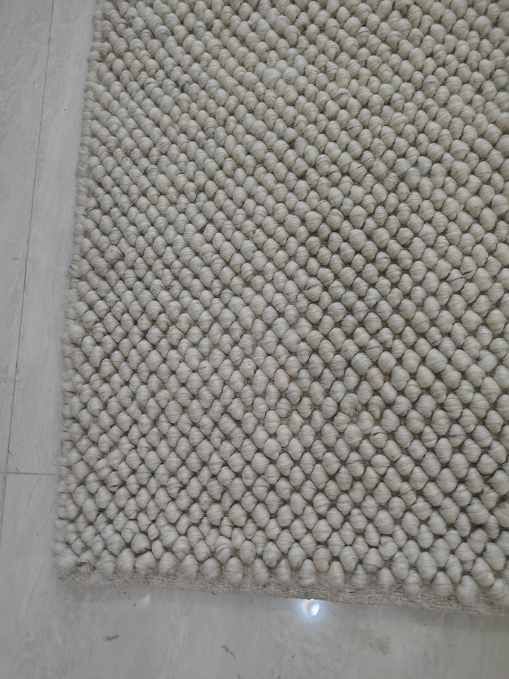 Translation missing: es.Plush textured cream rug styled for cozy Scandinavian interior