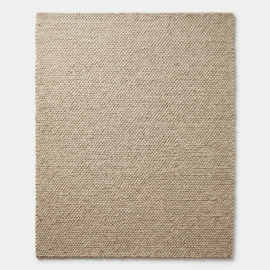 Translation missing: es.Top-down view of chunky cream area rug with structured edges