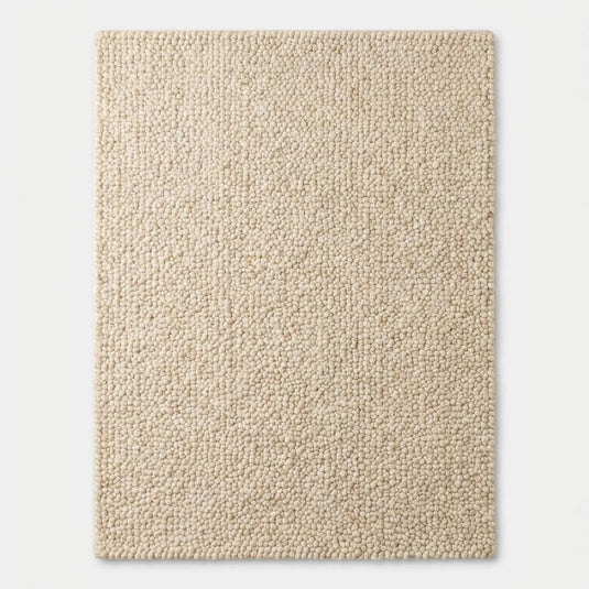 Translation missing: es.Chunky textured neutral area rug with thick looped plush surface in cozy living room setting