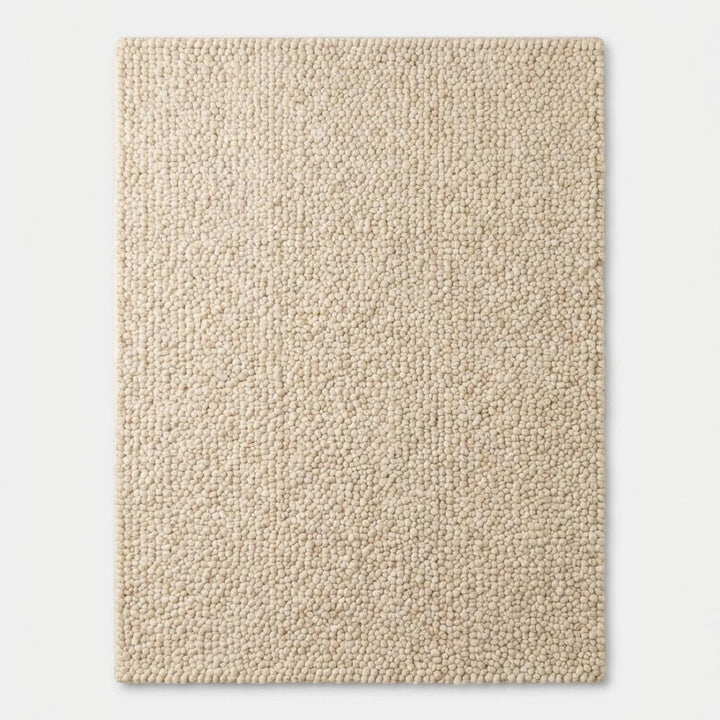 Translation missing: es.Chunky textured neutral area rug with thick looped plush surface in cozy living room setting