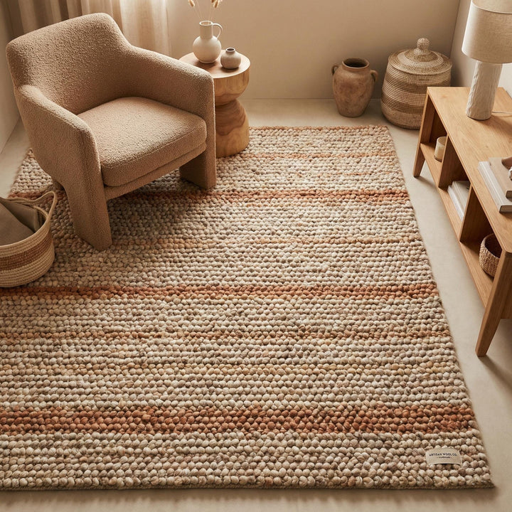 Translation missing: es.Chunky wool area rug with neutral warm stripes and thick textured loops in cozy modern living room