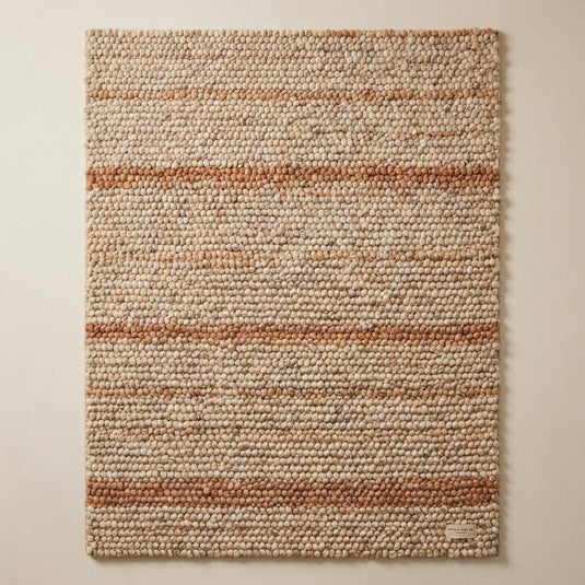 Translation missing: es.Top-down view of dense chunky wool rug with cream and rust toned striping