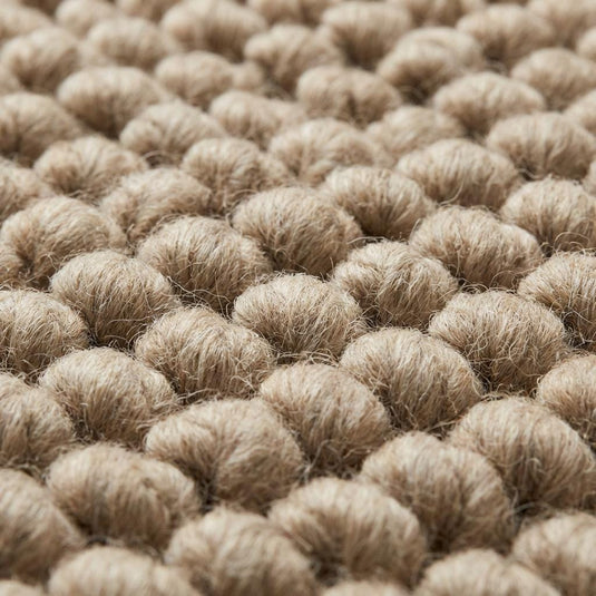Translation missing: es.Chunky wool area rug with thick, braided neutral beige texture in living room
