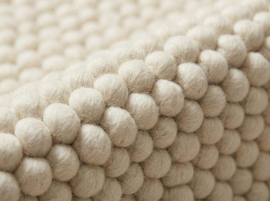 Translation missing: es.Chunky wool ivory area rug with thick textured oversized loops in Scandinavian neutral living room setting